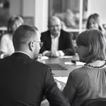 Ein Familienunternehmen bei einem geschäftlichen Meeting, bei dem Strategien und Lösungen diskutiert werden.